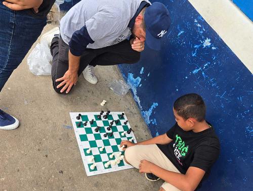 Coach Russ plays chess anywhere