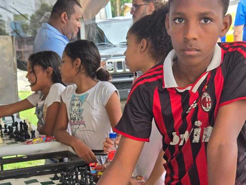 Boy learning chess on the streets