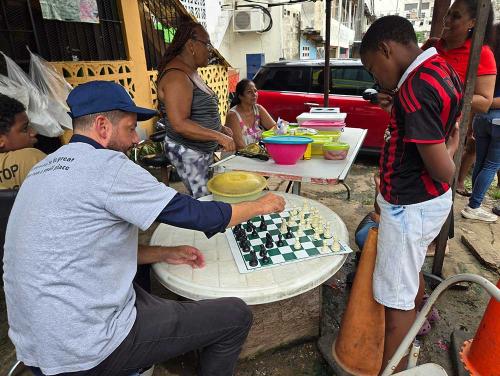 Coach Russ plays chess on Panama streets